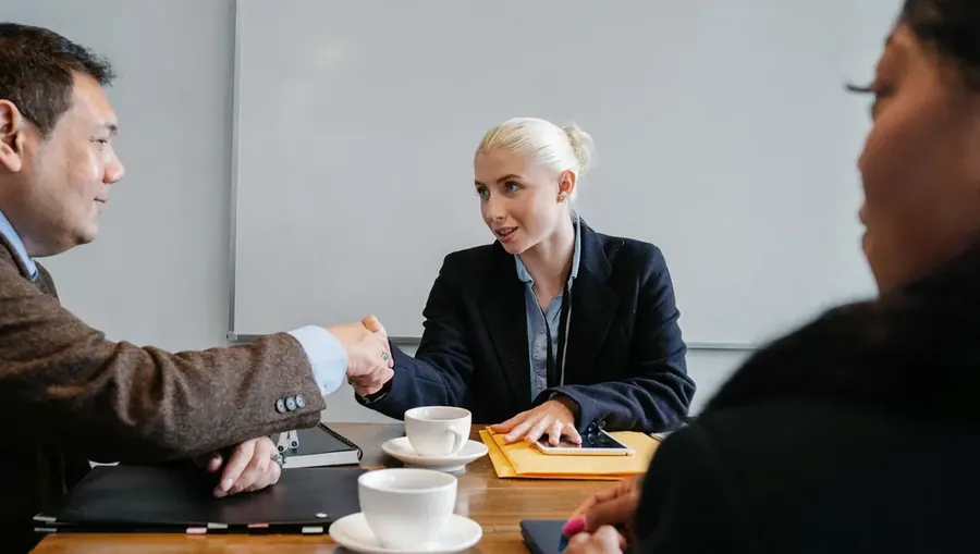 A meeting across a desk in an office